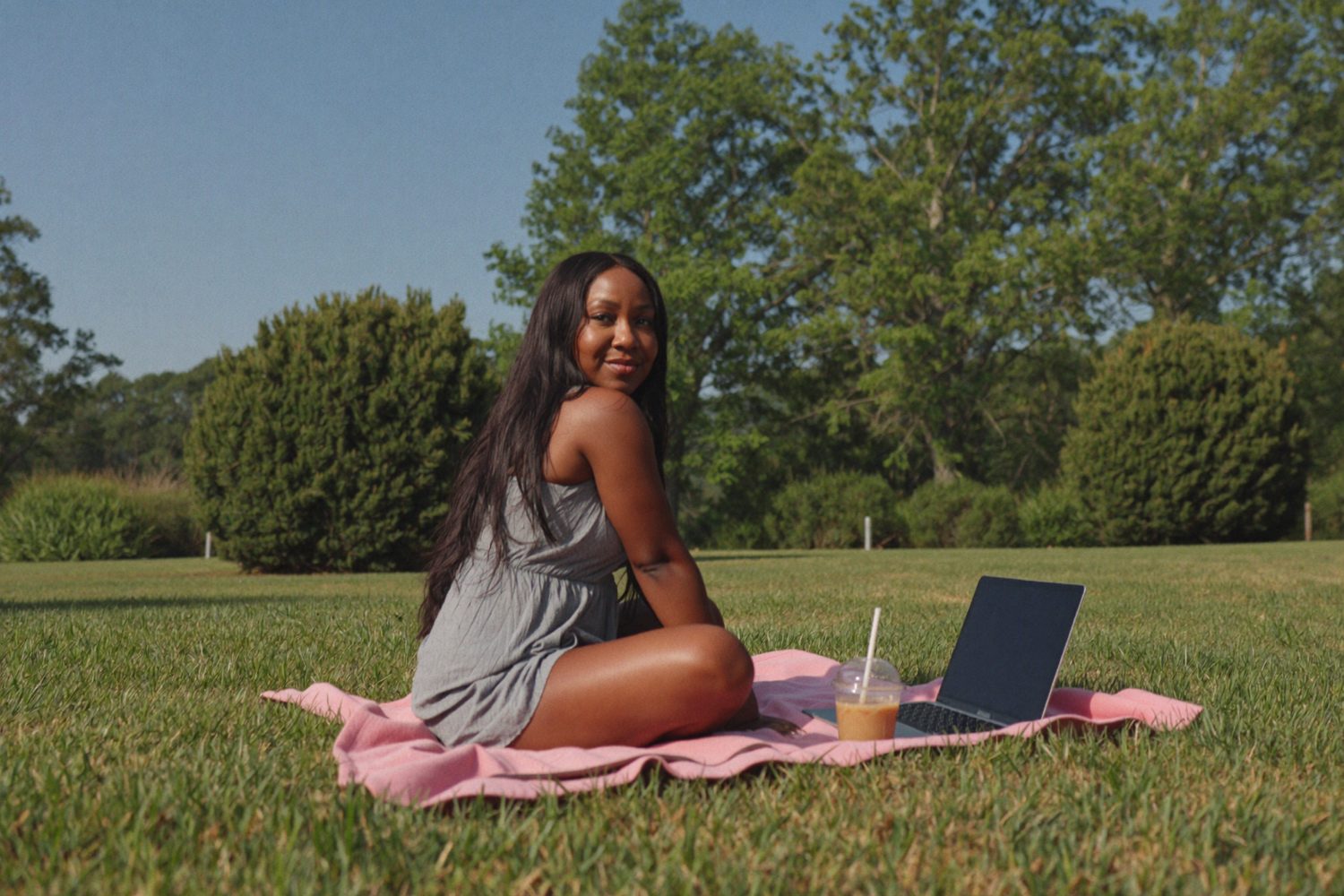 Rochelle working outdoors with her laptop